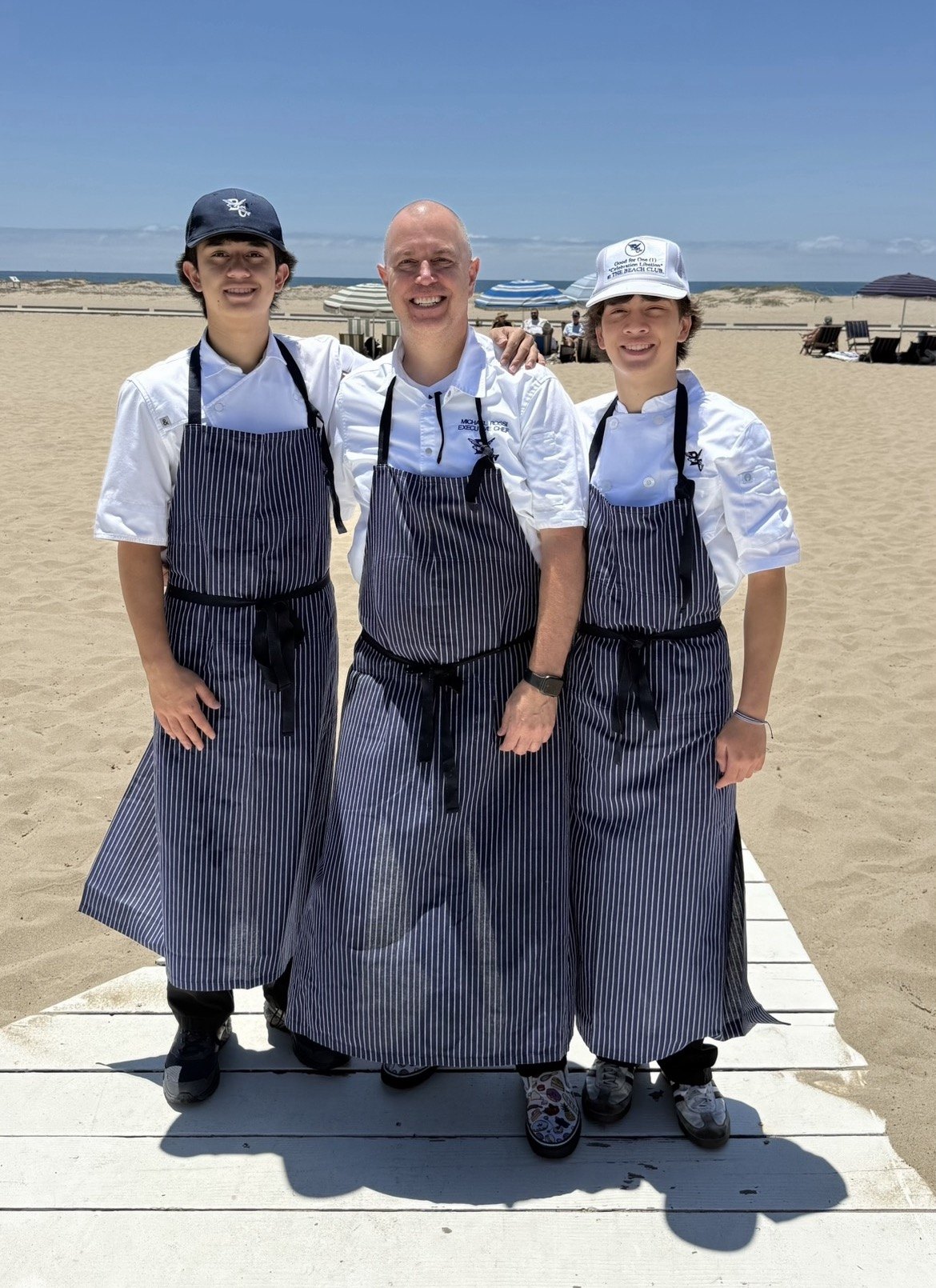 Chef Michael Rossi with his sons Maddox and Luca in chef whites at The Beach Club on Father's Day